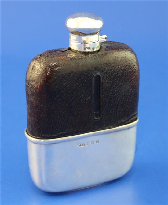 A George V silver and leather mounted glass hip flask, 5.75in.